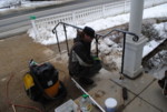Leveling and plumbing the railing with wedges.